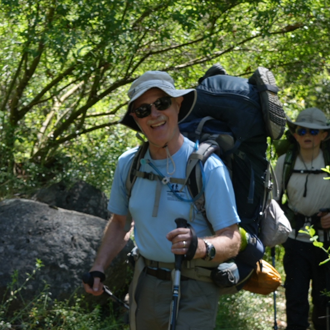 Steven J. Giampaoli, Scoutmaster of Troop 803, backpacking on a wooded trail